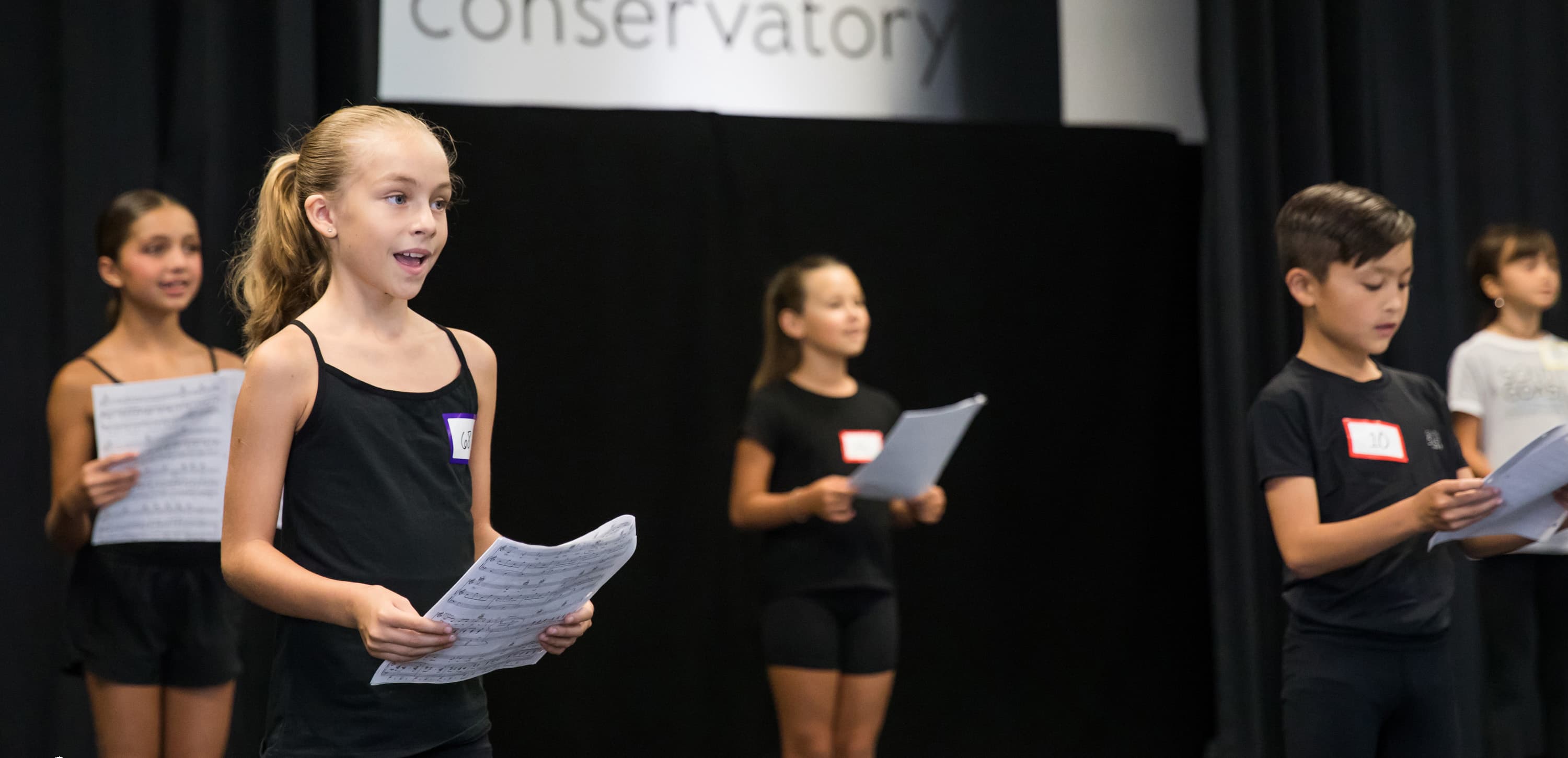 Students participating in a singing and acting class
